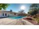 Inviting backyard with a sparkling pool, concrete patio, and beautiful landscaping for outdoor enjoyment at 4014 W Anderson Dr, Glendale, AZ 85308
