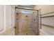Shower featuring tile surround, shampoo niche, and glass enclosure at 4014 W Anderson Dr, Glendale, AZ 85308