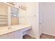 Bright bathroom features a single sink vanity with a large mirror and a view of a bathtub at 516 N Emery --, Mesa, AZ 85207
