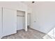 Bedroom featuring wood-look floors, an open closet, and doorway to bathroom at 516 N Emery --, Mesa, AZ 85207