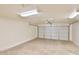 Spacious garage with concrete floor and a white paneled garage door at 516 N Emery --, Mesa, AZ 85207