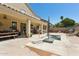 Backyard featuring a spa, covered patio, and ample seating for outdoor entertaining with a waterfall feature at 5309 W Angela Dr, Glendale, AZ 85308