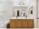 Bathroom vanity with double sinks, soaking tub, and walk-in shower and closet at 5309 W Angela Dr, Glendale, AZ 85308