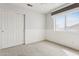 Clean bedroom with ample natural light and closet space, providing a functional and comfortable living area at 5309 W Angela Dr, Glendale, AZ 85308