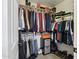 Walk-in closet featuring an organized layout with multiple hanging rods, shelves, and designated shoe storage at 5309 W Angela Dr, Glendale, AZ 85308