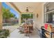 Inviting covered patio with dining table, ceiling fan, and views of the backyard and lush landscaping at 5309 W Angela Dr, Glendale, AZ 85308