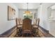 Elegant dining room featuring hardwood floors and a decorative rug under the dining table at 5309 W Angela Dr, Glendale, AZ 85308