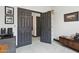 Hallway featuring gray doors and trim, with white walls and light tile flooring at 5309 W Angela Dr, Glendale, AZ 85308