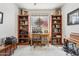 Charming home office with a vintage desk, built-in bookshelves, and plenty of natural light at 5309 W Angela Dr, Glendale, AZ 85308