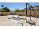 Inviting backyard hot tub with a stone waterfall feature and ample space for lounging at 5309 W Angela Dr, Glendale, AZ 85308