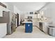 Bright kitchen featuring white cabinetry, stainless steel appliances, and a contrasting blue island at 5309 W Angela Dr, Glendale, AZ 85308