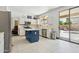 Spacious kitchen with white cabinets, island, stainless appliances, leading to a backyard pool area at 5309 W Angela Dr, Glendale, AZ 85308