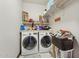 Functional laundry room with washer, dryer, and ample shelving for storage at 5309 W Angela Dr, Glendale, AZ 85308