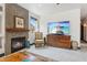 Stylish living room with fireplace, media cabinet, and decor; television features beach view at 5309 W Angela Dr, Glendale, AZ 85308