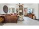 Comfortable living room with a large leather couch, decorative wall art, and a cozy fireplace at 5309 W Angela Dr, Glendale, AZ 85308