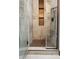 Modern walk-in shower with sleek tile walls, decorative mosaic tile accent, and contemporary bronze shower fixture at 5309 W Angela Dr, Glendale, AZ 85308