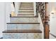 Close-up of elegant staircase featuring decorative iron railing and tile risers at 5309 W Angela Dr, Glendale, AZ 85308