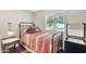 Guest bedroom with iron bed frame, wood-look flooring, and a mini-fridge at 5402 E Mckellips Rd # 298, Mesa, AZ 85215
