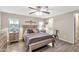 Bedroom features a bed with striped comforter, matching nightstands, and an attached bathroom at 5402 E Mckellips Rd # 298, Mesa, AZ 85215