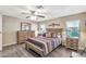 A comfy bedroom featuring a bed with striped comforter, matching nightstands, and wood-look flooring at 5402 E Mckellips Rd # 298, Mesa, AZ 85215