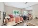 Cozy bedroom with an iron bed frame, study desk, wood-look flooring, and sliding mirror door closet at 5402 E Mckellips Rd # 298, Mesa, AZ 85215