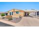 Inviting single-story home featuring a covered carport and low-maintenance desert landscaping at 5402 E Mckellips Rd # 298, Mesa, AZ 85215