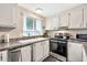 Well-maintained kitchen featuring white cabinets, and modern appliances at 5402 E Mckellips Rd # 298, Mesa, AZ 85215