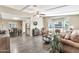 Open-concept living room with wood floors flowing into the dining area and kitchen at 5402 E Mckellips Rd # 298, Mesa, AZ 85215