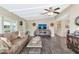 Open living room with wood floors, a ceiling fan, and access to other areas at 5402 E Mckellips Rd # 298, Mesa, AZ 85215