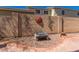 Enclosed backyard with brick accent wall, decorative sun art, and stylish lounge space at 5430 S 23Rd Way, Phoenix, AZ 85040