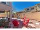 Inviting backyard featuring a brick patio, red Adirondack chairs, BBQ, and covered seating area at 5430 S 23Rd Way, Phoenix, AZ 85040