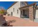Exterior backyard showcasing a large brick patio, inviting covered front porch, and manicured landscaping at 5430 S 23Rd Way, Phoenix, AZ 85040