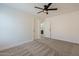 Well-lit bedroom with carpet, modern ceiling fan, and entry to the en-suite bathroom at 5430 S 23Rd Way, Phoenix, AZ 85040