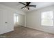 Bedroom featuring plush carpet, mirrored closet and bright window for natural light at 5430 S 23Rd Way, Phoenix, AZ 85040