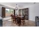Elegant dining room with a wood table, leather chairs, and modern light fixture at 5430 S 23Rd Way, Phoenix, AZ 85040