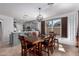 Bright dining room with a wood table, and stylish light fixtures with a view to the kitchen at 5430 S 23Rd Way, Phoenix, AZ 85040