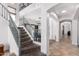 Expansive foyer with a staircase and arches, providing an elegant transition to the living spaces at 5430 S 23Rd Way, Phoenix, AZ 85040