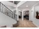 Grand foyer with a staircase and arched doorways, showcasing an open and airy design at 5430 S 23Rd Way, Phoenix, AZ 85040