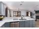 Stylish kitchen with stainless appliances, quartz countertops and views to the dining room at 5430 S 23Rd Way, Phoenix, AZ 85040