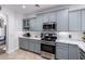 Updated kitchen features modern appliances, gray cabinets, and light countertops at 5430 S 23Rd Way, Phoenix, AZ 85040