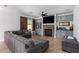 Cozy living room with stone fireplace, custom built-ins, and a comfortable gray sofa at 5430 S 23Rd Way, Phoenix, AZ 85040