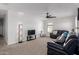 Relaxing living room featuring a comfortable black leather sofa and a large television at 5430 S 23Rd Way, Phoenix, AZ 85040