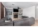 Spacious living room with a stone fireplace, custom cabinets, and tile floors at 5430 S 23Rd Way, Phoenix, AZ 85040