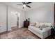 Cozy living room with a white sofa, dark wood furniture, and a view to the bathroom at 5430 S 23Rd Way, Phoenix, AZ 85040