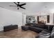 Comfortable living room featuring tile flooring, a gray sofa, and stylish light fixtures at 5430 S 23Rd Way, Phoenix, AZ 85040