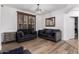 Inviting living room featuring modern sofas, wood shutters, and a stylish light fixture at 5430 S 23Rd Way, Phoenix, AZ 85040