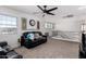 Cozy living room on the upper level features a black leather sofa and natural light at 5430 S 23Rd Way, Phoenix, AZ 85040