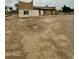 Exterior view of the new home construction with dirt lot and puddle of water at 5550 E Shea Blvd, Scottsdale, AZ 85254