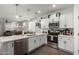 Bright kitchen with white cabinets, stainless appliances, and open view of living spaces at 5712 S Parkwood --, Mesa, AZ 85212