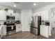 Clean kitchen featuring white cabinetry, stainless steel appliances and modern finishes at 5712 S Parkwood --, Mesa, AZ 85212